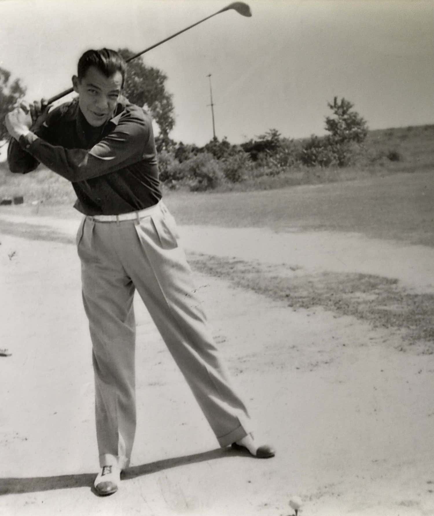 c: 1935 Chester Simms swinging a golf club