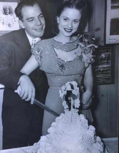 Chester and Marie Simms cutting a wedding cake