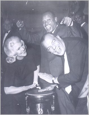 Chester Simms playing a bongo with Peggy Lee and Lionel Hampton